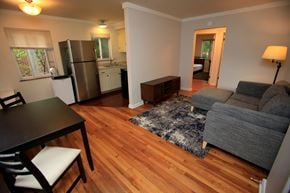 Ann Arbor apartment for rent - A living room with a grey couch and a black table.