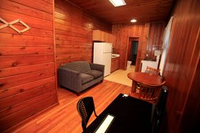 Ann Arbor apartment for rent - A small room with a couch, chair, table and a refrigerator.