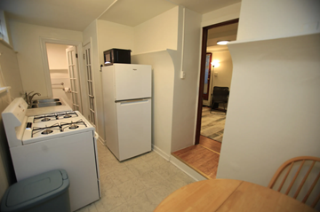 Ann Arbor apartment for rent - A small kitchen with a stove and a refrigerator.