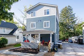 Ann Arbor apartment for rent - A two-story house with a garage and a covered porch.