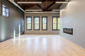 Ann Arbor apartment for rent - A spacious room with wooden floors and large windows.