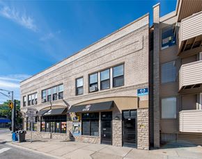 Ann Arbor apartment for rent - A street view of a building with a blue sign on the right side.