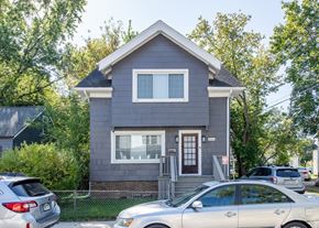Ann Arbor apartment for rent - A grey house with a car parked in front.