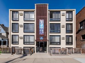 Ann Arbor apartment for rent - A building with a blue and white sign on the front.