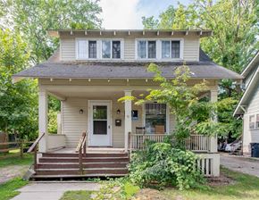 Ann Arbor apartment for rent - A small house with a front porch and a brown door.