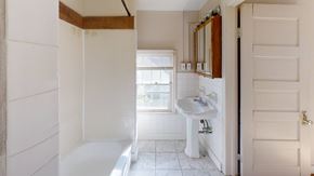 Ann Arbor apartment for rent - A white bathroom with a sink and mirror.