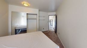 Ann Arbor apartment for rent - A bedroom with a large bed and a small closet.