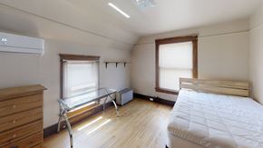 Ann Arbor apartment for rent - A bedroom with a bed, dresser, window, and air conditioner.
