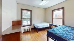 Ann Arbor apartment for rent - A bedroom with a bed, a window, and a radiator.