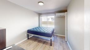 Ann Arbor apartment for rent - A bedroom with a bed, dresser, and window.