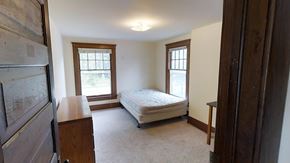 Ann Arbor apartment for rent - A bedroom with a bed, dresser, and window.