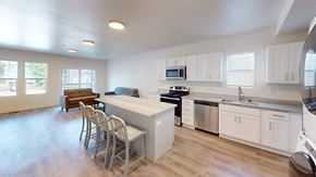 Ann Arbor apartment for rent - A kitchen with white cabinets and a wooden floor.