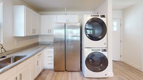 Ann Arbor apartment for rent - A modern kitchen with a stainless steel refrigerator and a white dishwasher.