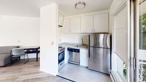 Ann Arbor apartment for rent - A kitchen with stainless steel appliances and white cabinets.