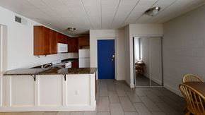 Ann Arbor apartment for rent - A kitchen with a blue door and white cabinets.