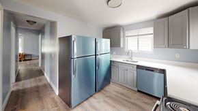 Ann Arbor apartment for rent - A kitchen with a blue refrigerator and wooden floors.