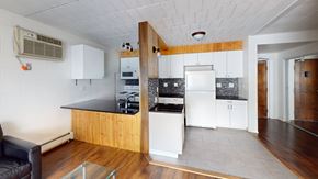 Ann Arbor apartment for rent - A kitchen with a black counter top and white cabinets.