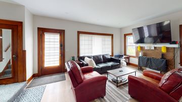 Ann Arbor apartment for rent - A living room with red leather chairs and a black couch.