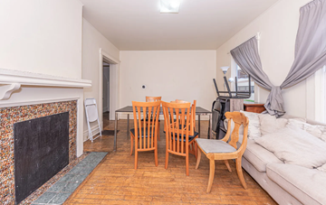 Ann Arbor apartment for rent - A living room with a fireplace and a dining table set up.