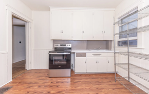 Ann Arbor apartment for rent - A kitchen with white cabinets and a wooden floor.