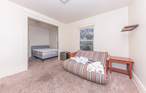 Ann Arbor apartment for rent - A bedroom with a single bed and a sofa.