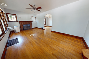 Ann Arbor triplex for rent - A room with a fireplace and a fan.