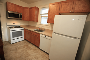 Ann Arbor apartment for rent - A kitchen with a white fridge, stove, and microwave.