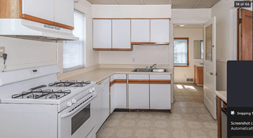 Ann Arbor apartment for rent - A kitchen with white cabinets and a white stove top oven.