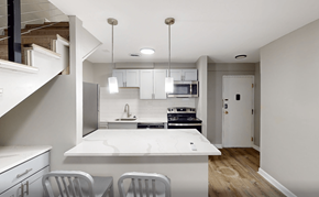 Ann Arbor apartment for rent - A modern kitchen with white countertops and stainless steel appliances.