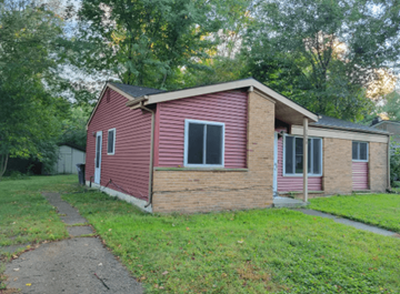 Ann Arbor apartment for rent - A red house with a white door and a window.
