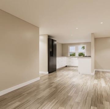 Ann Arbor apartment for rent - A kitchen with a black refrigerator and wooden flooring.