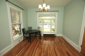 Ann Arbor apartment for rent - A room with a wooden floor and a table with two chairs.