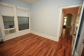 Ann Arbor apartment for rent - A room with a window and wooden floors.