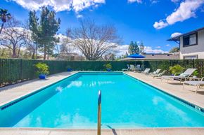Escondido apartment for rent - a swimming pool with chairs and umbrellas next to a house