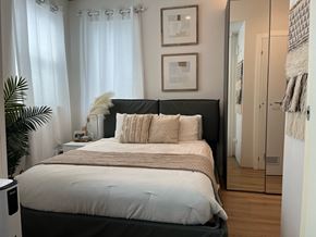 Los Angeles apartment for rent - a bedroom with a large bed in front of a window