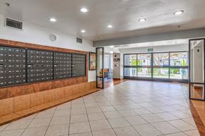 Corona apartment for rent - a locker room in a school with a tiled floor and a glass door with a view
