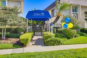 Huntington Beach apartment for rent - A blue canopy with the word "Sunshine" written on it is above a gate.