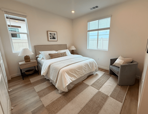 Azusa apartment for rent - A bedroom with a large bed and a chair.