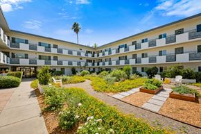 Pasadena apartment for rent - A sunny day at a courtyard with a building in the background.