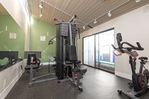 Claremont apartment for rent - A gym with a treadmill, elliptical trainer and a stationary bike.