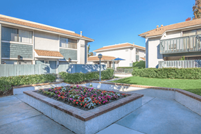 Buena Park apartment for rent - a flower bed in the middle of a walkway between two buildings