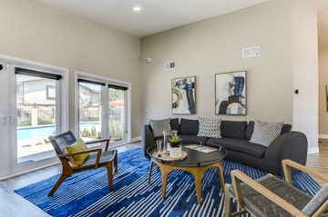 Glendora apartment for rent - A living room with a blue rug and a grey couch.