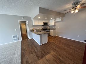 Anaheim apartment for rent - the view of a kitchen and living room from the entryway of an empty house