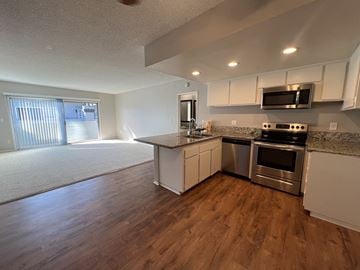 Anaheim apartment for rent - A kitchen with a stove top oven and microwave.