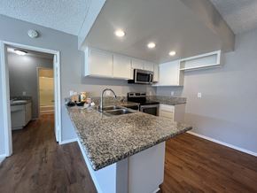 Anaheim apartment for rent - an open kitchen with granite counter tops and a sink