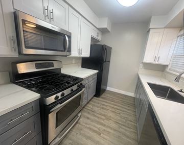 Arcadia apartment for rent - A kitchen with a black refrigerator and stove.