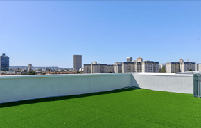 Los Angeles apartment for rent - a lawn on the roof of a building with a city in the background