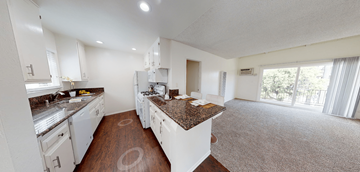 Huntington Beach apartment for rent - A kitchen with white cabinets and a granite countertop.