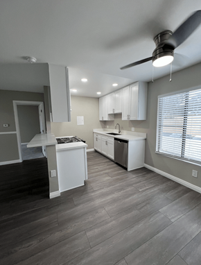 Buena Park apartment for rent - A kitchen with a white counter top and a ceiling fan.