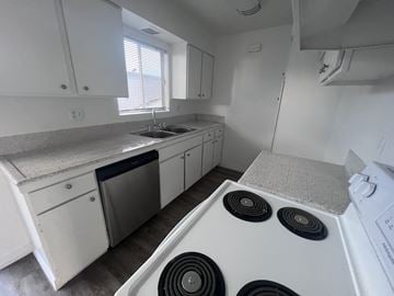 Garden Grove apartment for rent - A white kitchen with a stove top oven and a dishwasher.